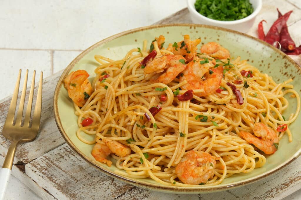 Garlic Butter Shrimp Noodles garnished with parsley and lemon